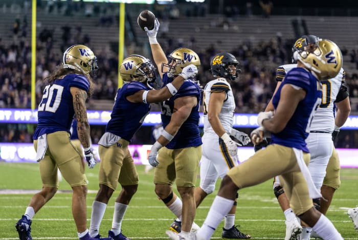 Washington Huskies defensive back Asa Turner (20), defensive back Kyler Gordon (2), second from left, celebrate after linebacker Ryan Bowman (55), center, recovered a California Golden Bears fumble.